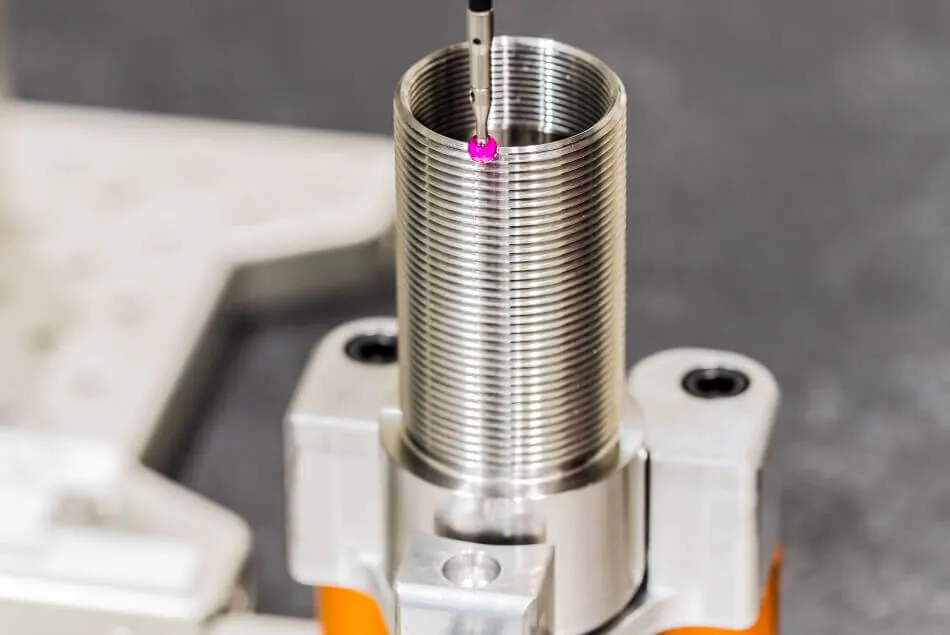 Coordinate measuring machine inspecting a machined part